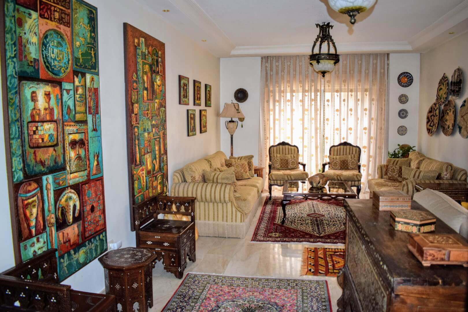 Arabic living room, with Syrian furniture, mother of pearl, rugs, carpets, artworks, woven baskets